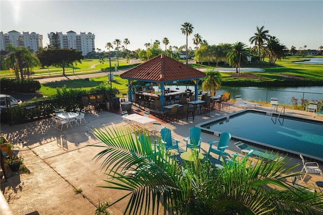 view of swimming pool with a gazebo and a water view