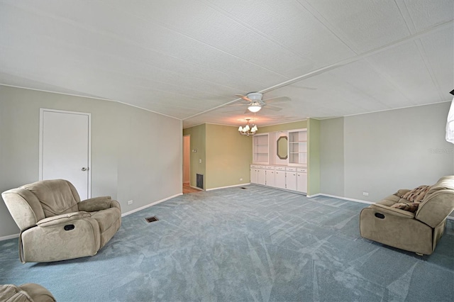 sitting room with a textured ceiling, a notable chandelier, and carpet flooring