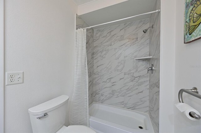 bathroom featuring toilet and a shower with shower curtain