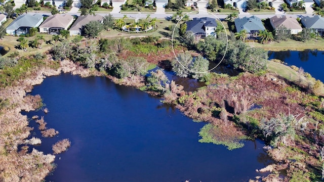 birds eye view of property featuring a water view