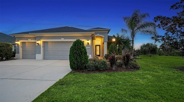 view of front of home featuring a garage and a yard