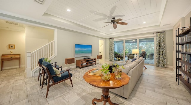 living room with ceiling fan, ornamental molding, wooden ceiling, and a raised ceiling