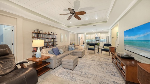 living room with a raised ceiling, ceiling fan, light tile patterned floors, and wood ceiling