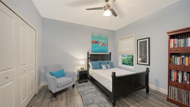 bedroom with dark wood-type flooring, ceiling fan, and a closet