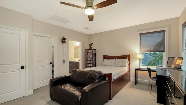 carpeted bedroom with sink, ensuite bath, and ceiling fan