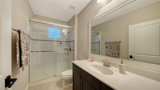 bathroom featuring toilet, an enclosed shower, tile patterned floors, and vanity