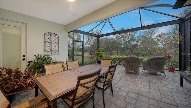 sunroom / solarium featuring ceiling fan