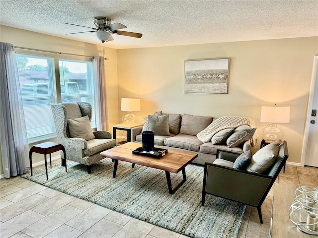 living room featuring light tile patterned floors, a textured ceiling, and ceiling fan