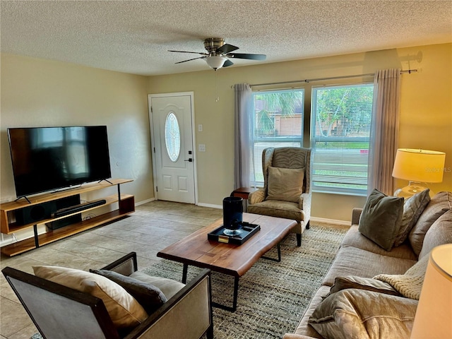 tiled living room with ceiling fan and a textured ceiling