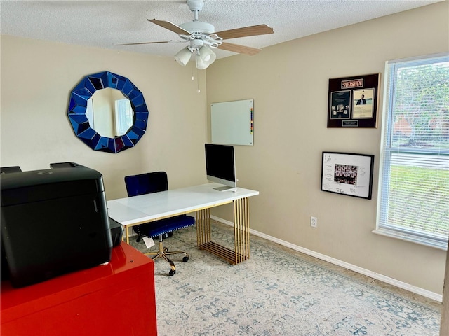 home office featuring ceiling fan and a textured ceiling