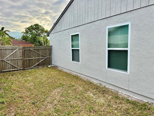 view of side of home featuring a lawn