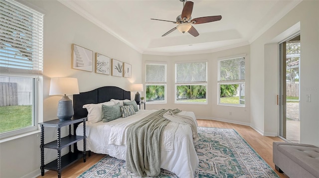 bedroom with crown molding, access to outside, light wood-style flooring, and baseboards