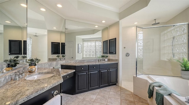 bathroom featuring tile patterned floors, a garden tub, a tile shower, crown molding, and a sink