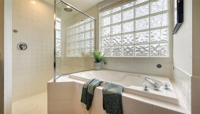 bathroom with a garden tub and walk in shower