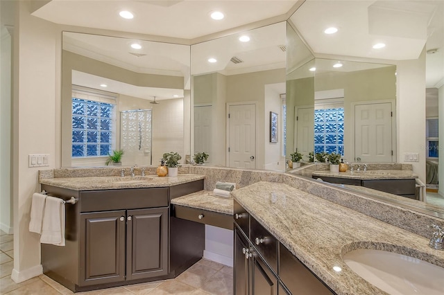 bathroom featuring ornamental molding, a stall shower, a sink, and tile patterned floors