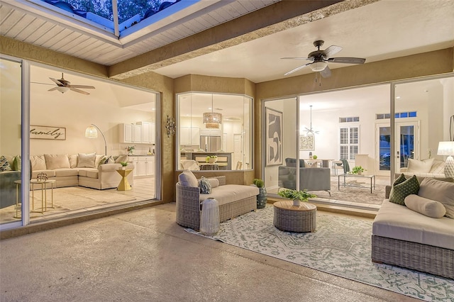 interior space featuring a ceiling fan, beam ceiling, concrete flooring, and french doors