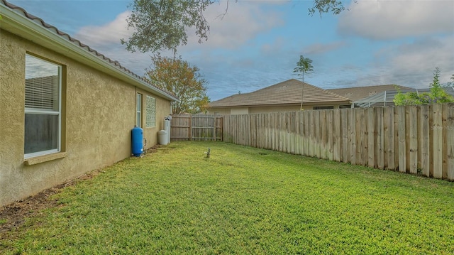 view of yard with a fenced backyard