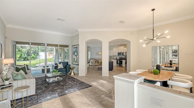 living area with light tile patterned floors, baseboards, arched walkways, ornamental molding, and a notable chandelier