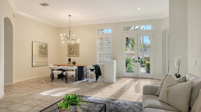 dining area with light tile patterned floors, visible vents, arched walkways, ornamental molding, and french doors