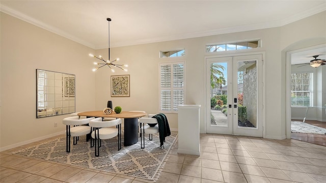 dining area with light tile patterned floors, baseboards, ornamental molding, french doors, and a notable chandelier