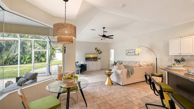 living room featuring a ceiling fan, visible vents, and light tile patterned floors