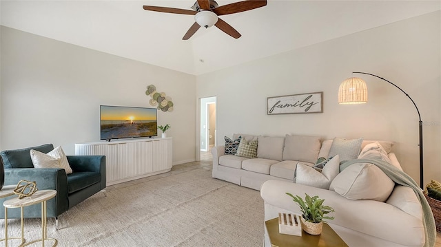 living room with lofted ceiling, light carpet, and ceiling fan