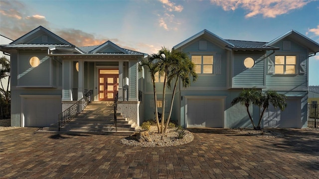 view of front facade with a garage and french doors