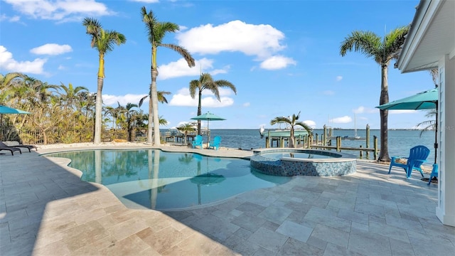 view of pool featuring a patio, an in ground hot tub, and a water view