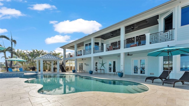 view of pool with a gazebo, a patio, ceiling fan, and french doors