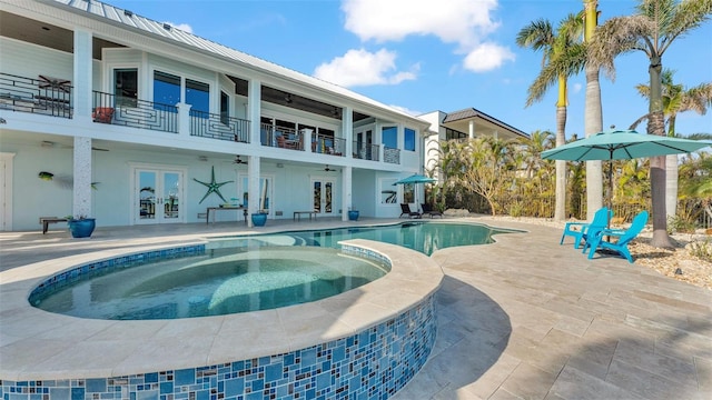 view of pool featuring ceiling fan, a patio area, french doors, and an in ground hot tub