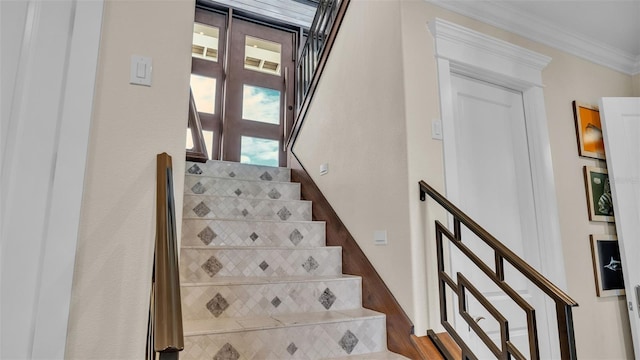 stairway with hardwood / wood-style floors and crown molding