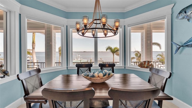 dining area featuring ornamental molding, a healthy amount of sunlight, and a water view