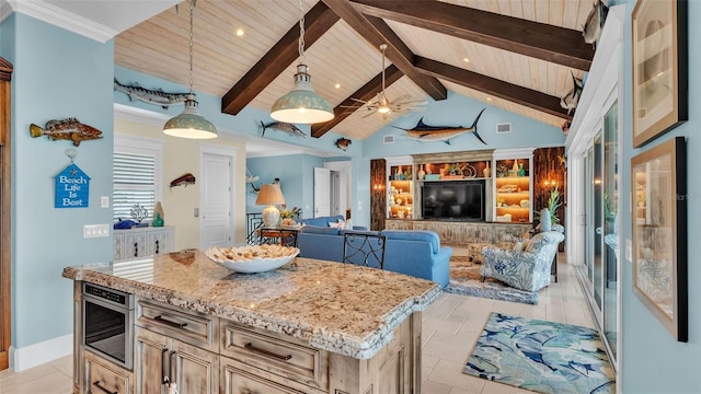 kitchen with a kitchen island, ceiling fan, beam ceiling, and decorative light fixtures