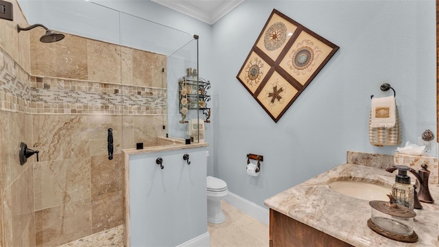 bathroom with ornamental molding, a tile shower, vanity, and toilet