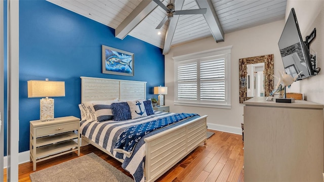 bedroom with wooden ceiling, hardwood / wood-style flooring, ceiling fan, and vaulted ceiling with beams