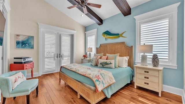 bedroom featuring ceiling fan, light hardwood / wood-style floors, and vaulted ceiling with beams