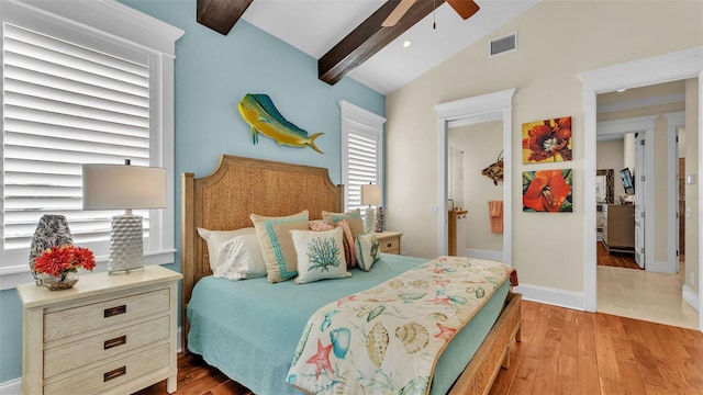 bedroom featuring lofted ceiling with beams, ceiling fan, and light wood-type flooring