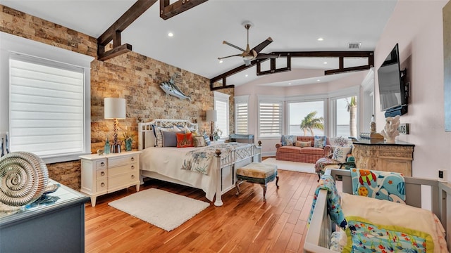 bedroom featuring ceiling fan, light hardwood / wood-style flooring, and vaulted ceiling with beams