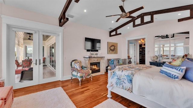 bedroom with wood-type flooring, lofted ceiling with beams, ceiling fan, french doors, and access to exterior