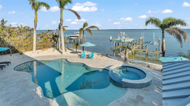 view of swimming pool featuring a dock, an in ground hot tub, and a water view