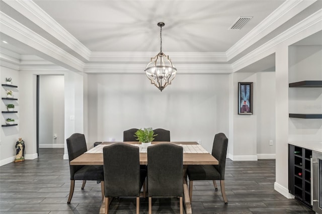 dining space with dark hardwood / wood-style floors, built in features, ornamental molding, and an inviting chandelier