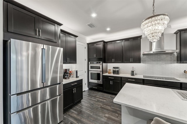 kitchen with a notable chandelier, decorative light fixtures, stainless steel appliances, and tasteful backsplash