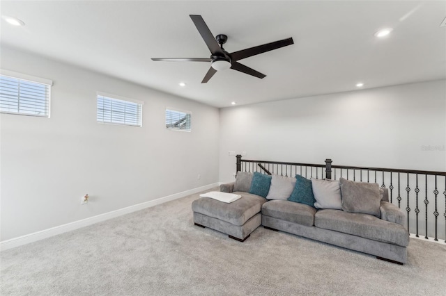 carpeted living room with ceiling fan and plenty of natural light