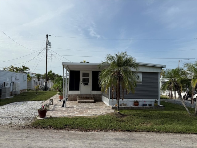 2601 Gulf Dr N Unit S2, Bradenton Beach, FL 34217 - manufactured / mobile home featuring entry steps, a front lawn, and a patio area