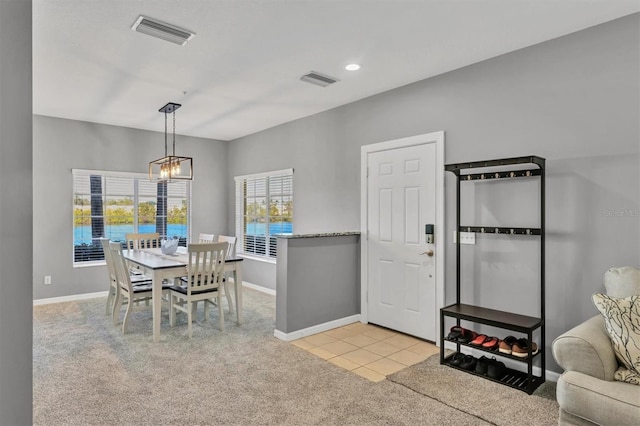 tiled dining area with a notable chandelier