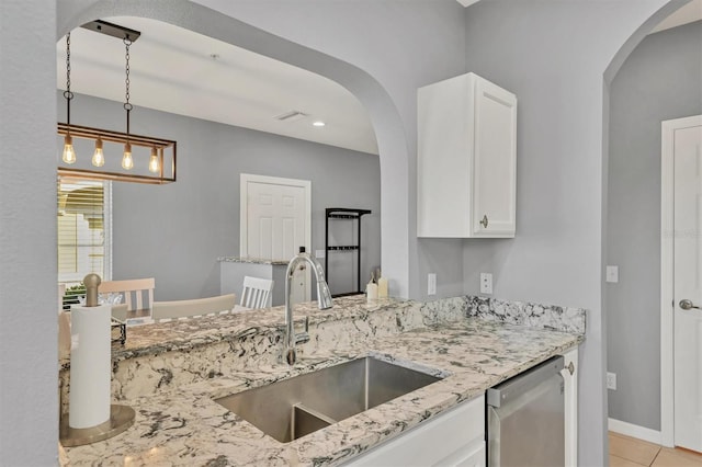 kitchen featuring white cabinetry, dishwasher, sink, light stone counters, and pendant lighting