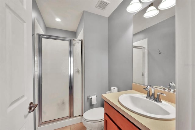 bathroom with tile patterned floors, vanity, toilet, and walk in shower