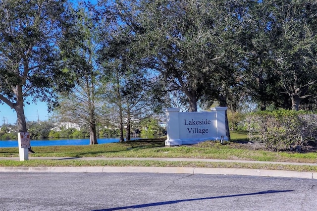 community / neighborhood sign with a water view