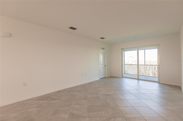 empty room with light tile patterned flooring