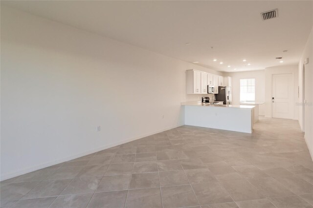 unfurnished living room featuring light tile patterned floors